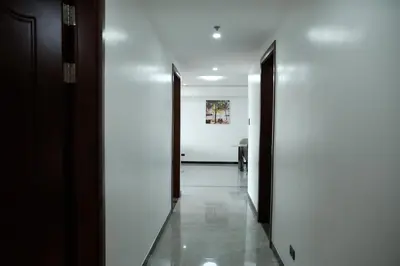 a hallway with two doors and a white wall at Golden Seagulls Hotel in Manila