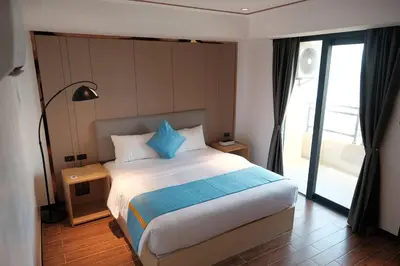 a bedroom with a large bed with blue pillows at Golden Seagulls Hotel in Manila