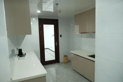 a kitchen with white counters and a brown door at Golden Seagulls Hotel in Manila