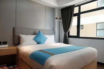 a bedroom with a large bed and a window at Golden Seagulls Hotel in Manila