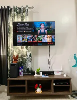 a flat screen tv hanging on a wall at Cozy Condominium at Amaia Steps Nuvali in Pitland