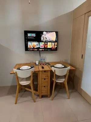 a room with a table and two chairs and a tv at Cozy Brio the 2nd Sm Jazz Makati in Manila