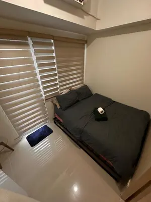 a small bed in a room with a window at Cozy Brio the 2nd Sm Jazz Makati in Manila