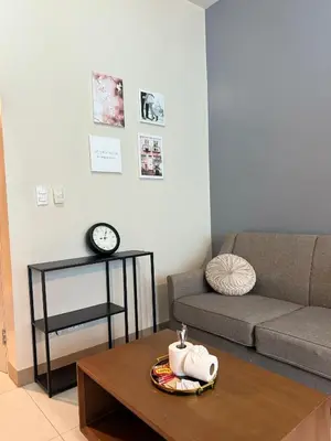a living room with a couch and a coffee table at Cozi 1br suite Grand Hyatt BGC wifi pool in Manila