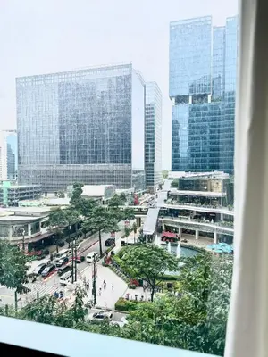 a view of a city with many tall buildings at Cozi 1br suite Grand Hyatt BGC wifi pool in Manila