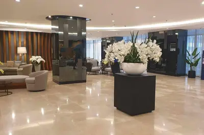 a lobby with a vase of flowers on a table at Shore 2 Tower 3 Condo near MOA by Dei Gratia in Manila