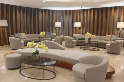 a living room with a large couch and chairs and tables at Shore 2 Tower 3 Condo near MOA by Dei Gratia in Manila