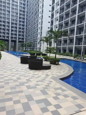 a courtyard in a building with a pool and buildings at Shore 2 Tower 3 Condo near MOA by Dei Gratia in Manila