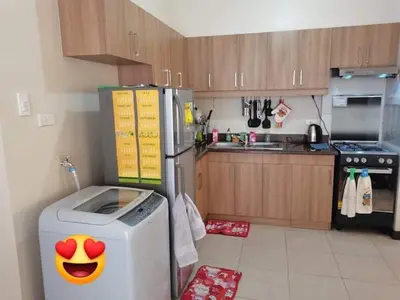 a kitchen with a dishwasher and a refrigerator with a face on it at 3BR Condo Unit at Mirea Residences in Manila