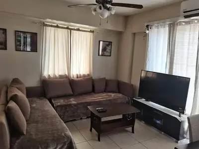 a living room with a couch and a flat screen tv at 3BR Condo Unit at Mirea Residences in Manila