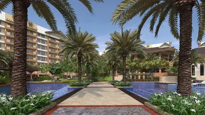 a courtyard with palm trees and a building at 3BR Condo Unit at Mirea Residences in Manila