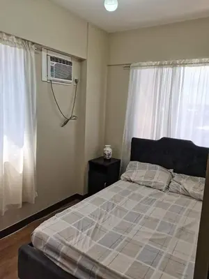 a bedroom with a bed and a window at 3BR Condo Unit at Mirea Residences in Manila