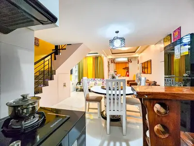 a kitchen and dining room with a table and chairs at Calm House near Enchanted Kingdom Sta Rosa with Free Parking, Wifi, Netflix in Santa Rosa