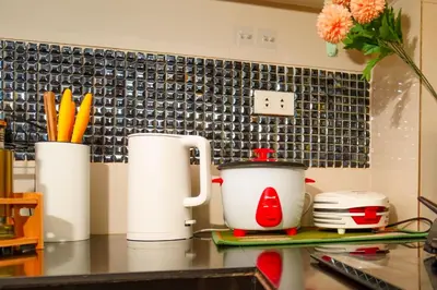 a kitchen counter with two cups and a tea kettle at Calm House near Enchanted Kingdom Sta Rosa with Free Parking, Wifi, Netflix in Santa Rosa