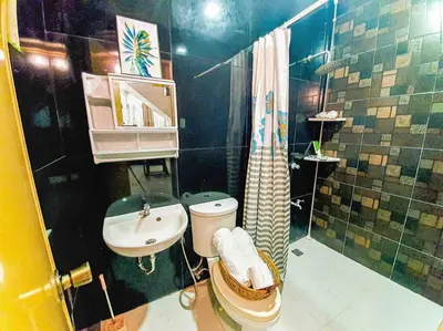 a bathroom with a sink and a toilet and a shower at Calm House near Enchanted Kingdom Sta Rosa with Free Parking, Wifi, Netflix in Santa Rosa