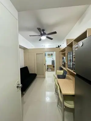 a kitchen and dining room with a ceiling fan at Cozy condo by the MRT & Light Mall experience comfort and convenience in Manila