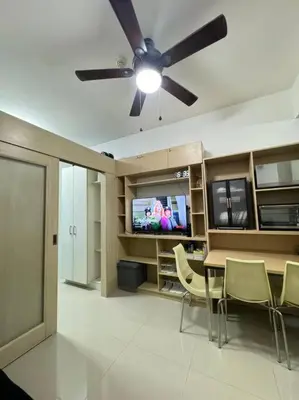 a dining room with a ceiling fan and a table and chairs at Cozy condo by the MRT & Light Mall experience comfort and convenience in Manila