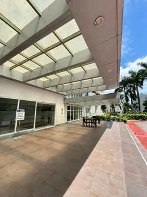 a large building with a patio with tables in it at Cozy condo by the MRT & Light Mall experience comfort and convenience in Manila