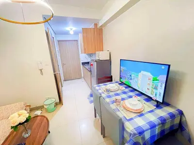 a kitchen with a table with a computer on it at SHORE 2 Residences MOA in Manila