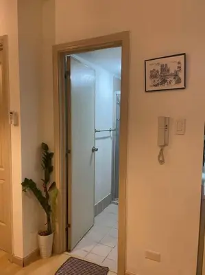 a hallway with a door leading to a bathroom at SOHO Central 1 Bedroom with Balcony near MRT EDSA SHAW PIONEER Greenfields SM Megamall Ortigas in Manila