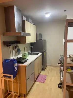 a kitchen with a sink and a refrigerator at SOHO Central 1 Bedroom with Balcony near MRT EDSA SHAW PIONEER Greenfields SM Megamall Ortigas in Manila