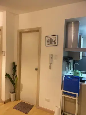 a kitchen with a white door in a room at SOHO Central 1 Bedroom with Balcony near MRT EDSA SHAW PIONEER Greenfields SM Megamall Ortigas in Manila