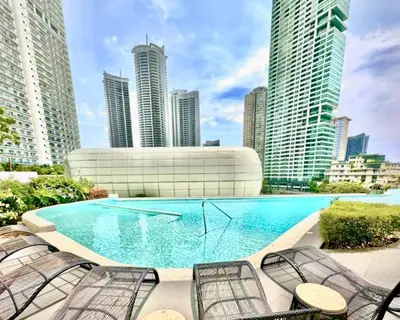 a large swimming pool in a city with tall buildings at The Hotel at Tower Acqua 1 in Manila