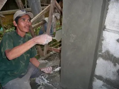 a man is working on a wall at Neighborhood Maricaban Pasay Rent in Manila