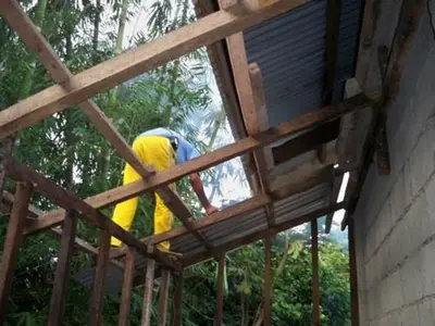a man is standing in a wooden structure at Neighborhood Maricaban Pasay Rent in Manila