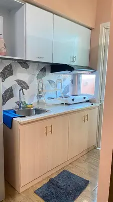 a kitchen with a sink and a counter at transient room anuva condominium in Manila