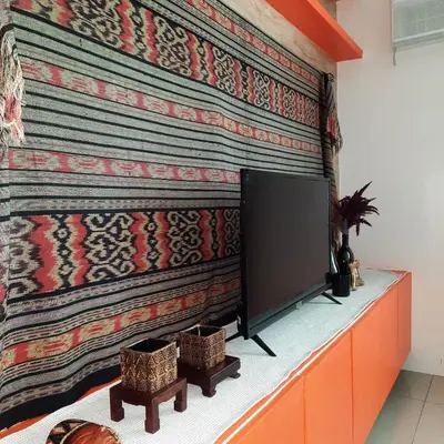 a living room with a large screen tv on a wall at Quaint One Br Apartment in Manila
