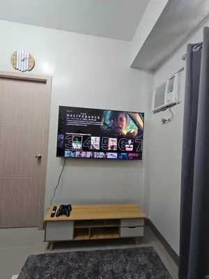 a room with a flat screen tv on the wall at DreamEscape by Charm Residences in Manila