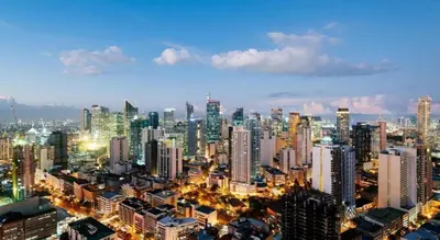 a large city at night with a lot of buildings at Amorsolo Mansion Hotel in Manila
