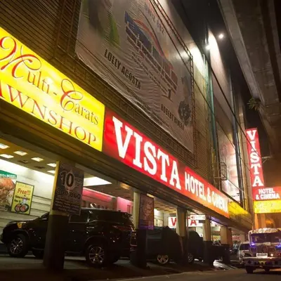 a building with a vista hotel sign on a street at Vista Hotel Recto in Manila