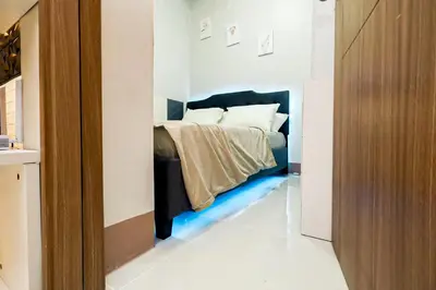 a bedroom with a bed with a blue floor at Sapphira Manor Luxurious Condo by the Bay in Manila