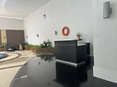 a living room with a black and white kitchen at QUITE Euro Luxe 3BR 7 mins walk to high street in Manila