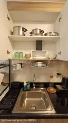 a kitchen with a sink and a counter top at Modern Rustic 1-Bed Condo in MoA Complex in Manila