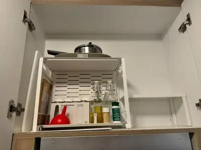 a cupboard with some items in it in a kitchen at Modern Rustic 1-Bed Condo in MoA Complex in Manila