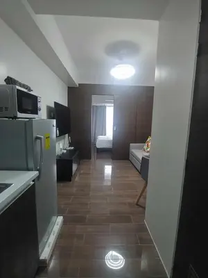 a room with a kitchen and a living room at 1br at Air Makati Ayala near Makati med in Manila