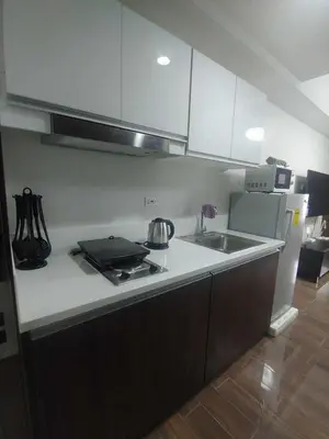 a kitchen with a sink and a counter top at 1br at Air Makati Ayala near Makati med in Manila