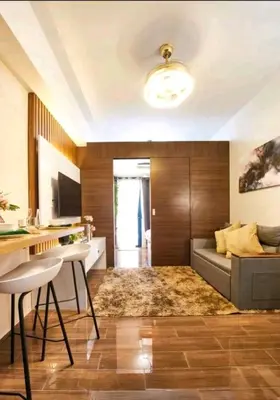 a living room with a couch and a table at 1br at Air Makati Ayala near Makati med in Manila