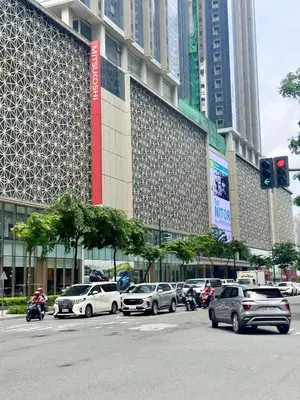 a busy city street with cars parked in front of a building at Cozy 1BR Condo with Uptown Mall View - BGC Zen Suite in Manila
