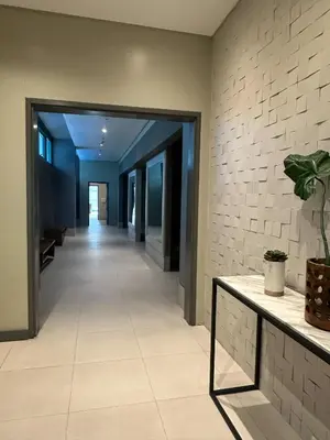 a hallway of a building with a plant on a table at Cozy 1BR Condo with Uptown Mall View - BGC Zen Suite in Manila