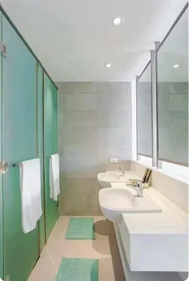 a bathroom with two sinks and a large mirror at Deluxe Studio good for 3 adults in Novotel Suites Manila with City View in Manila
