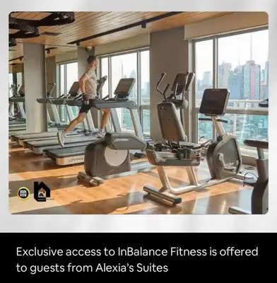 a man running on a treadmill in a gym at Deluxe Studio good for 3 adults in Novotel Suites Manila with City View in Manila