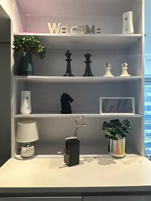 a shelf with vases and a lamp on a desk at Modern Chic 2BR with Panoramic Golf View in BGC in Manila
