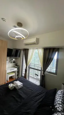 a bedroom with a bed and a large window at Cloud Nine Escape in Manila