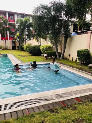 a group of children playing in a swimming pool at Simple Living in Anabu Primero