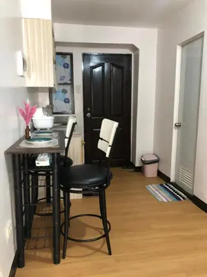 a kitchen with a table and chairs in a room at Simple Living in Anabu Primero