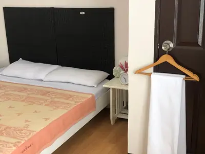 a bedroom with a bed with a black headboard at Simple Living in Anabu Primero